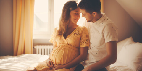 Young couple expecting a baby sitting indoors. Concept of family. - obrazy, fototapety, plakaty