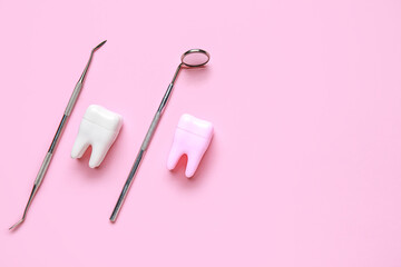 Dental tools and tooth models on pink background. World Dentist Day