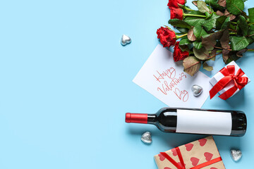 Bottle of wine with roses, gifts and postcard on blue background. Valentine's Day celebration