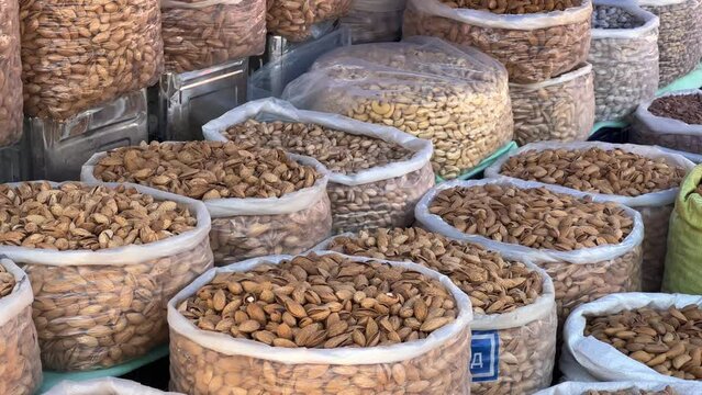 Dried Fruits, nuts and Spices market in Samarkand, Uzbekistan - June 29, 2023: Goods and traders at the Oriental Bazaar in Uzbekistan. Siab Bazaar is the largest and oldest bazaar in Samarkand. 4K