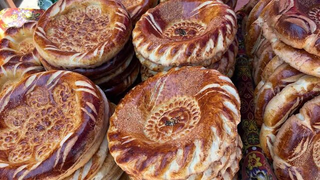 Tortillas on the market in Samarkand, Uzbekistan - June 29, 2023: Goods and traders at the Oriental Bazaar in Uzbekistan. Siab Bazaar is the largest and oldest bazaar in Samarkand. 4K