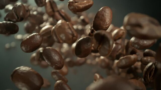 Super Slow Motion Detail Shot of Coffee Beans Flying and Rotating Towards Camera at 1000fps.