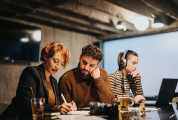 Executives planning late at a corporate office, analyzing sales stats, focused on business growth.