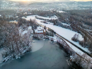 Aerial view of Bobovica lake near Samobor, Croatia, covered in white snow and thick ice during winter season