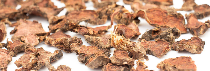 finely chopped dried Rhodiola rosea root close-up on a white isolated background