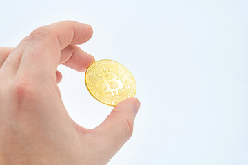 Close up of hand holding bitcoin crypto currency, future business. Hand holding golden bitcoin over...