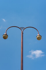 Lamp post isolated on blue sky, taken on broad daylight.