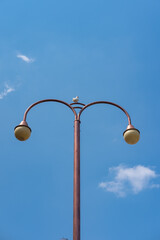 Lamp post isolated on blue sky, taken on broad daylight.