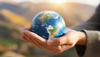Hands holding earth. Concept of protecting the world from global warming. Sustainability topic to...