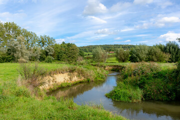 Summer landscape of hilly countryside of South Limburg (Zuid-Limburg) Small kleine Geul river in...