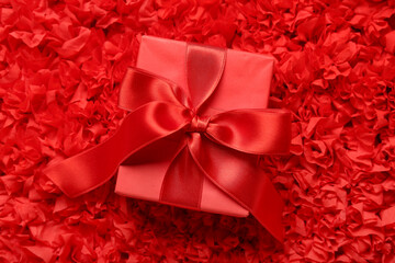 Gift box on red textured background. Valentine's Day celebration