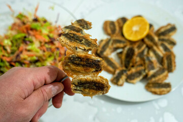 Anchovy fish fried with oil, lemon and salad on the side, Black Sea style,