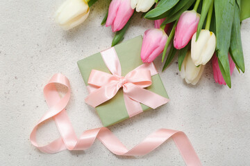 Gift box and bouquet of beautiful tulips on white background. International Women's Day