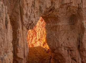 Bright Light Shines Through A Tunnel In A Hoodoo