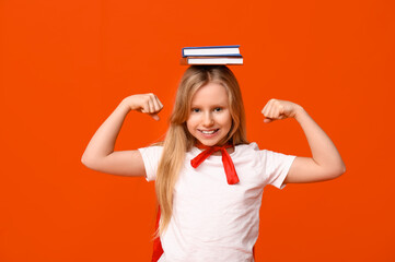 Cute teenage girl dressed as superhero with books on orange background. Library Lovers Day