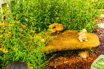 Concrete bench surrounded by flowers at Flowering Bridge Garden, Lake Lure North Carolina