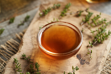 A bowl of thyme syrup on a table