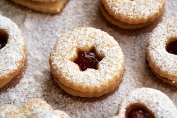 Fototapeta na wymiar Linzer Christmas cookies filled with strawberry marmalade and dusted with sugar