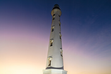 Famous California Lighthouse, on the island of Aruba. Colorful twilight sky behind, ranging from yellow to violet.
