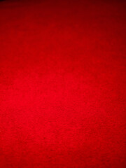 Red color saturated carpet surface. Selective focus. Textile material for floor