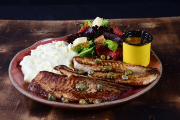 dish with mashed potato fish fillet and fried tilapia salad