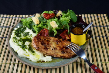 dish with mashed potato fish fillet and fried tilapia salad