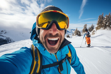Fototapeta na wymiar Happy skier in blue winter clothes taking selfie with his smartphone. Concept of young man having fun in weekend activity at vacation ski resort.