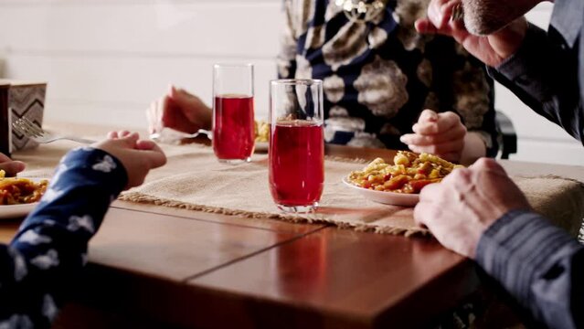 Rear view shot of holiday dining. A three people family. Concept of protestants family having a meal together. Daughter, mother and father at home dining room. Peaceful christians candid dinner
