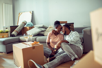 Young african couple moving in their new home apartment