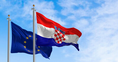 Flags of Croatia and the European Union fluttering together on a clear day