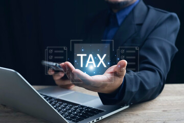 Fototapeta na wymiar E-tax Tax payment, TAX online payment and technology concept. Businessman using the laptop to fill in the income tax online return form for payment. Financial research, taxes calculation tax return.
