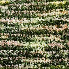 Seamless texture photo of green patterned synthetic calico carpet material.