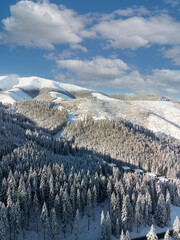 Aerial top view of scenic winter mountain landscape and Demanovska Dolina village. Drone...