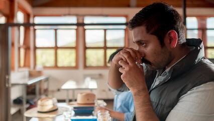 Latin taster performs a test of the quality of the coffee, appreciating the aroma.