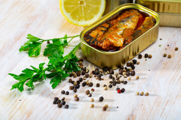 Open can of sardines on table