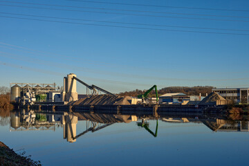 Fototapeta premium Riverside Manufacturing Hub. Eco-Friendly Technology and Production. industry and the environment, showcasing the integration of sustainable practices.