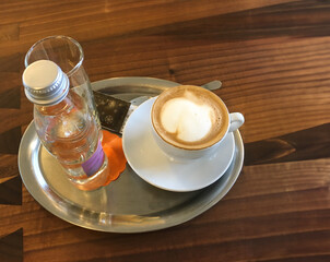 Cappuccino and bottled water at Slovenian restaurant