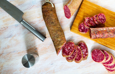 Appetizing salchichon sausage on wooden table