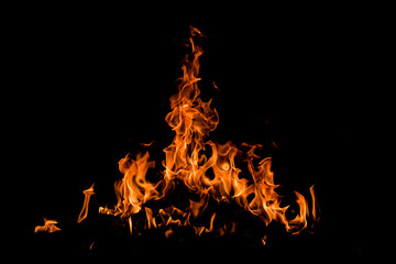 Fire over black background. Fire sparks background. Abstract dark background. Texture of fire on black background.