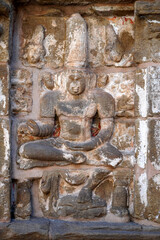 Bas relief of Hindu deity Sandstone sculpture. Ruins of ancient sculptures carved in the walls of Kanchi Kailasanathar temple in Kanchipuram, Tamilnadu.