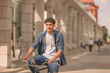 Portrait of a handsome Latin young man riding a bicycle in Guatemala City.