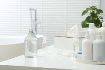 Fototapeta na wymiar Cosmetic travel kit on white countertop in bathroom. Bath accessories