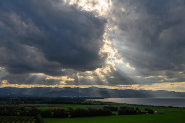 Naklejka na ściany i meble sun rays through dramatic clouds over mountains and sea in cyprus 6