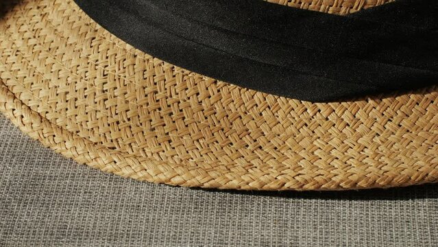 Texture of woven straw hat close-up. Headdress for vacation holidays. Sun hat