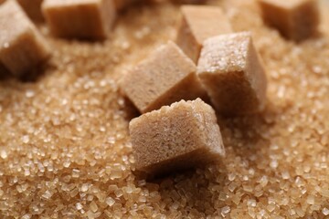 Different types of brown sugar as background, closeup