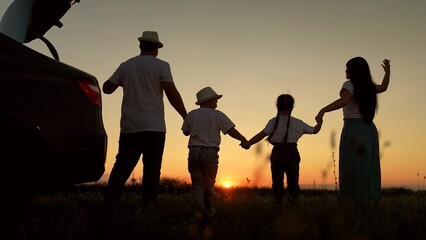 Dad with child, daughter on his shoulders, mom, children dance and admire beautiful sunset. Parents...