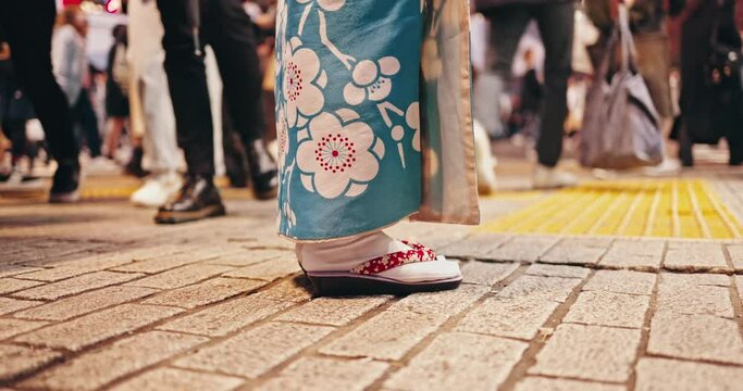 Japanese, woman and feet in city in kimono, urban town and wellness in street for buddhism heritage. Person, standing and travel in traditional clothes in tokyo culture or girl waiting with respect