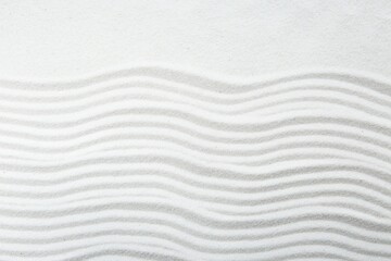 Zen rock garden. Wave pattern on white sand, top view