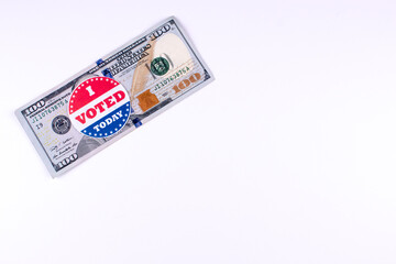 Stack of money with an I voted sticker on a white background symbolizing Election fraud.