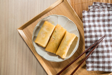 Fried Spring rolls on plate with chopsticks and spoon - Asian food style